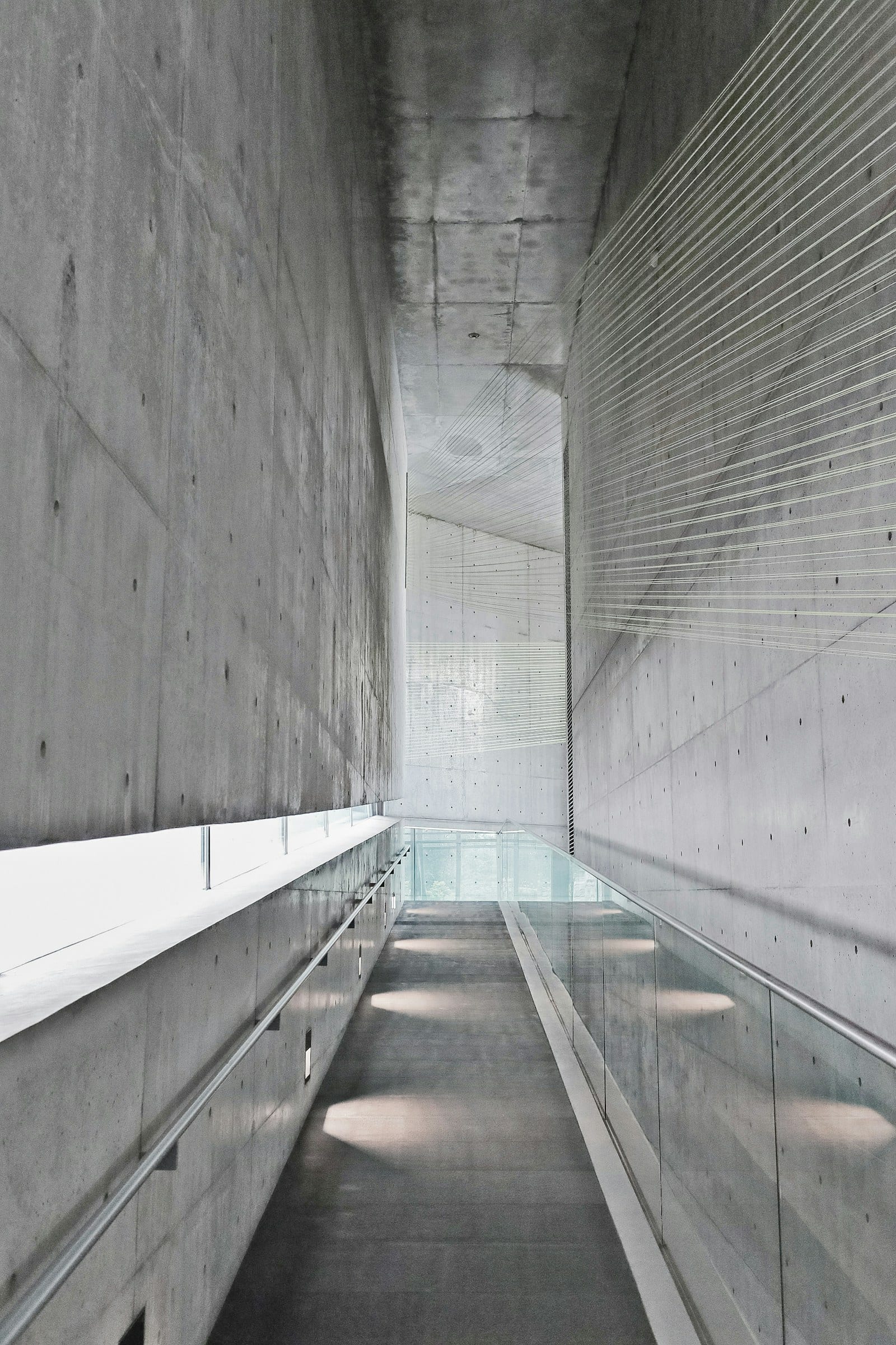 A long concrete corridor lit from above