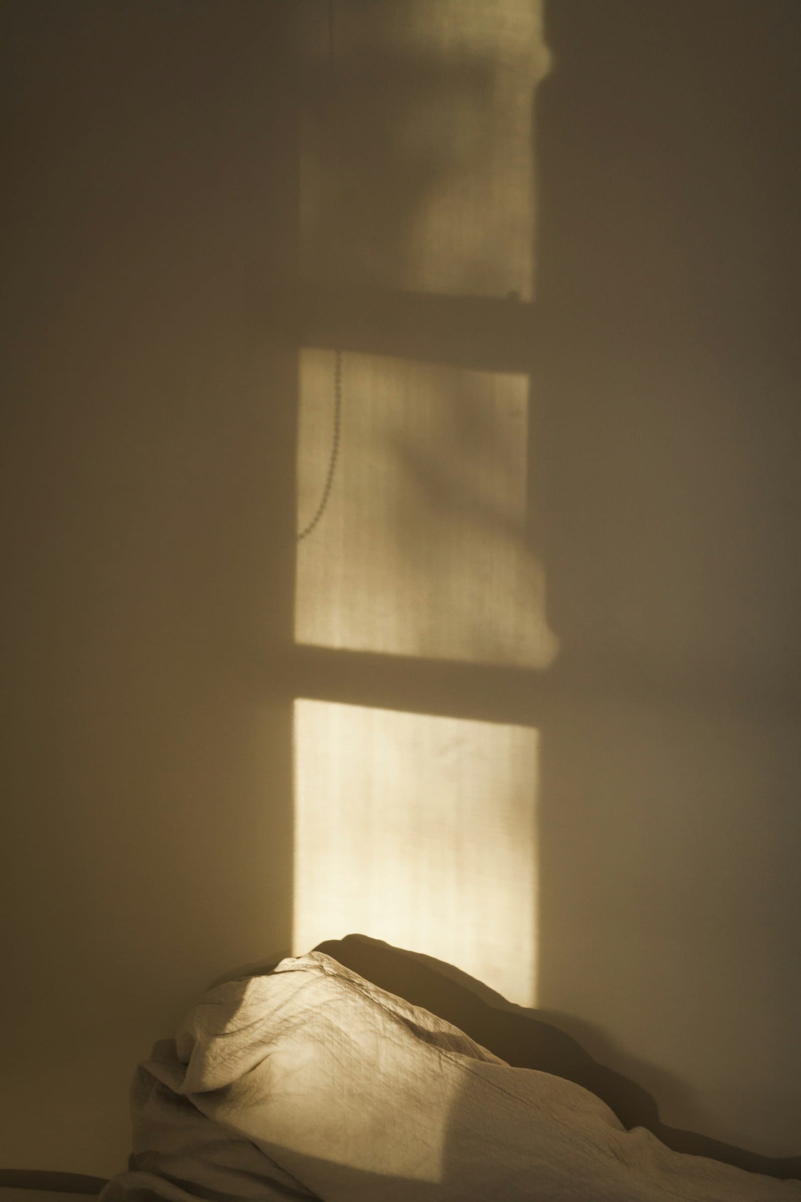 Late sun making a bright rectangle on a warm plaster wall