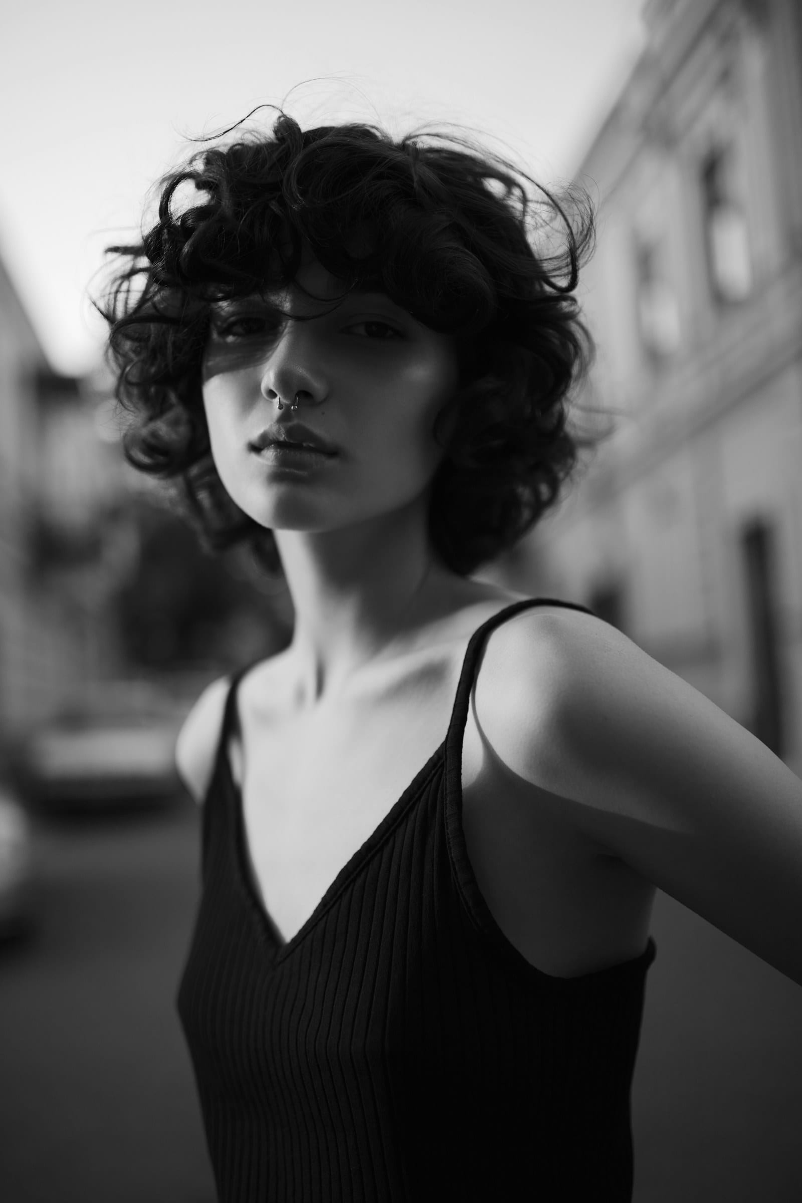A black and white portrait of a woman with short curly hair